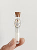 Quilt basting needles in a glass vial